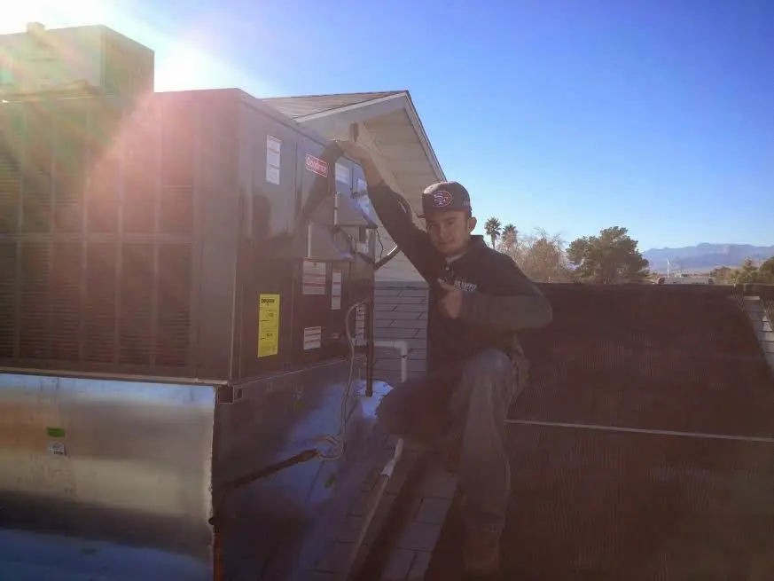HVAC technician performing Boiler Repair on a rooftop unit in Clearfield